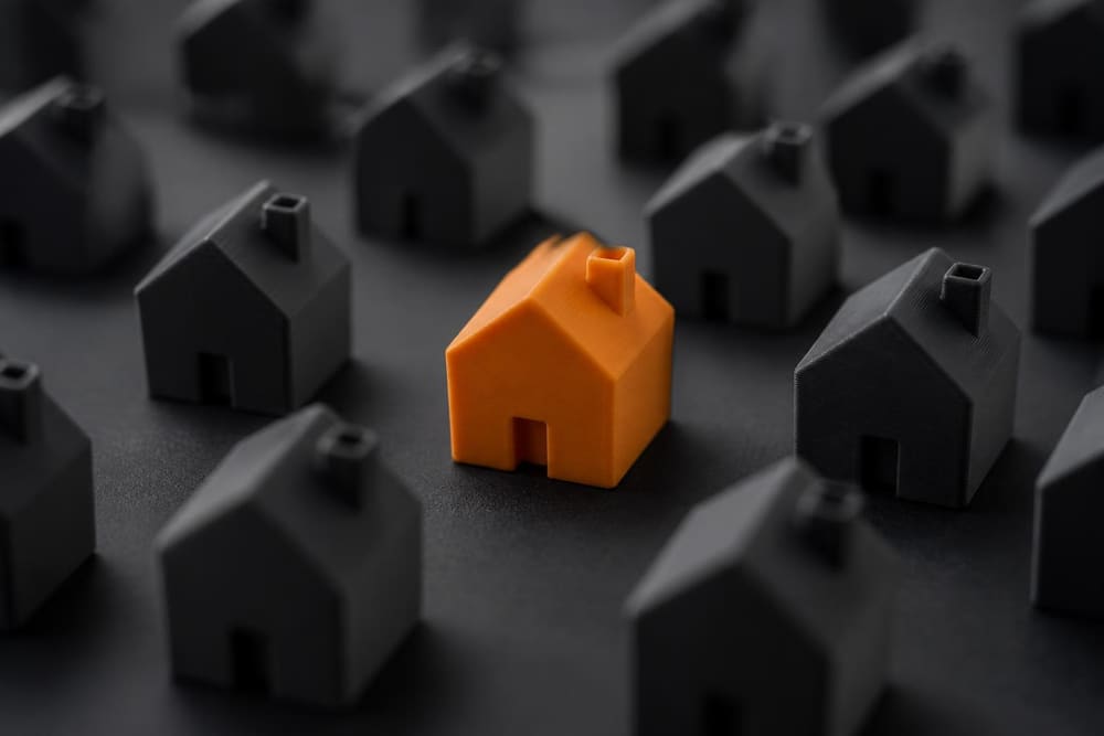 One orange house standing out in a row of dark houses